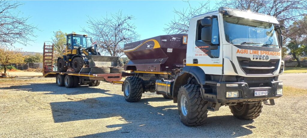 Self-propelled agricultural spreader truck and loader.